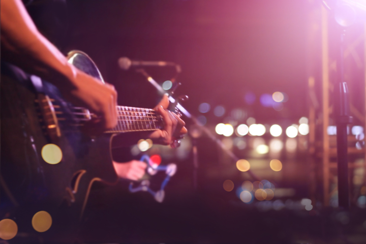 Image of person playing a guitar