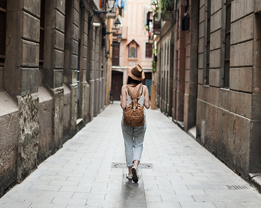 My travels my stories - woman walking through city corridor