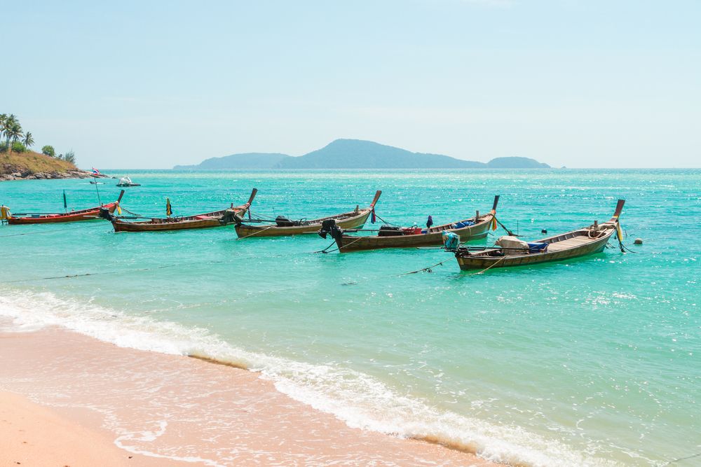 Fishing boats at Rawai Beach, where you can observe their local fishermen community.