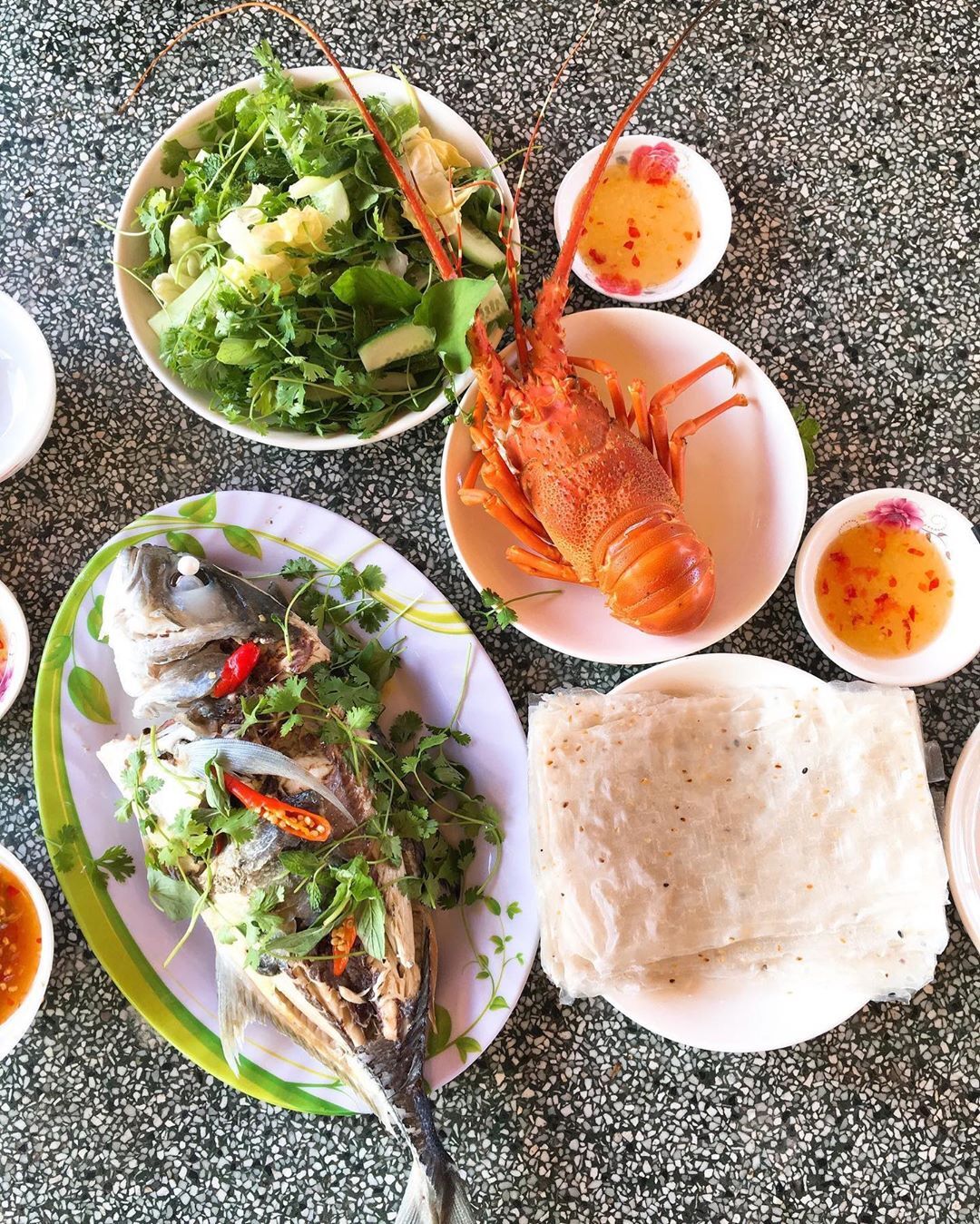 Tuck in to the freshest catch of the day at Vinh Hy Bay.