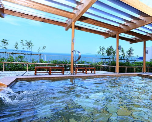 Take a dip in the hot tub at Mikawawan Resort Linx while admiring a picturesque ocean view.