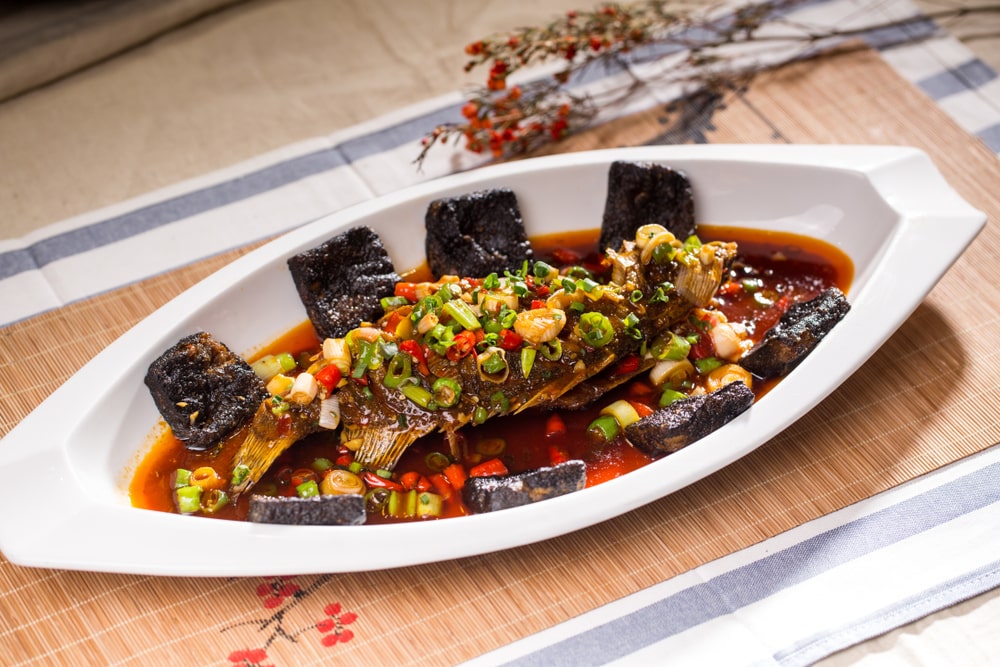  The stinky Red-Braised Fermented Mandarin Fish is traditionally marinated with salt, crammed tight under heavy stones in a barrel and left to ferment for eight days.