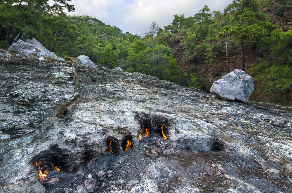 At Mount Chimaera, clusters of small fires naturally blaze from the vents in rocks that are scattered across the mountain.